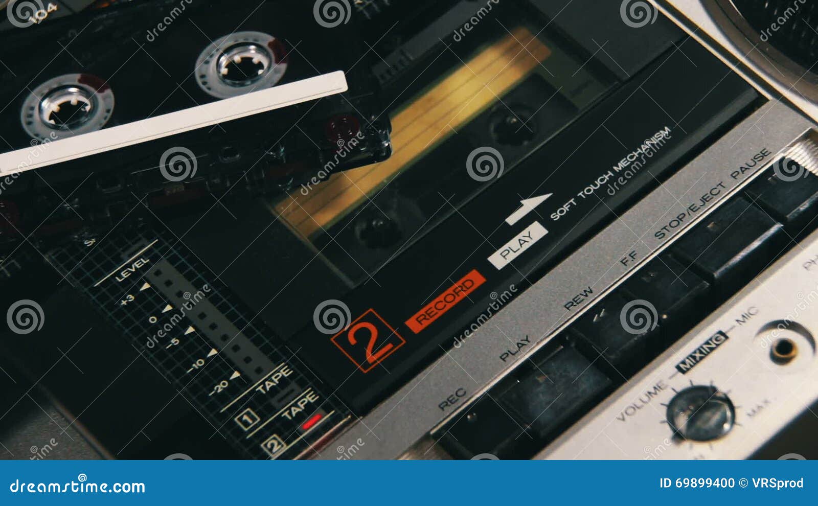 Pushing a Finger Play and Stop Button on a Two Decks Tape Recorder