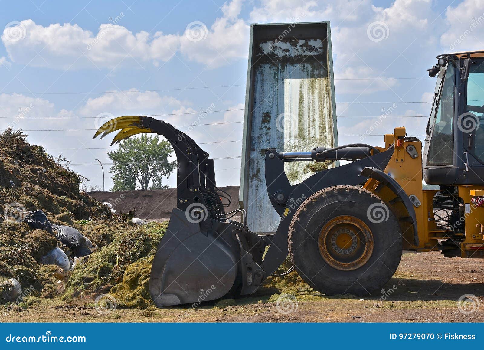 Pushing Grass Trimmings into a Compost Stock Photo Image of park