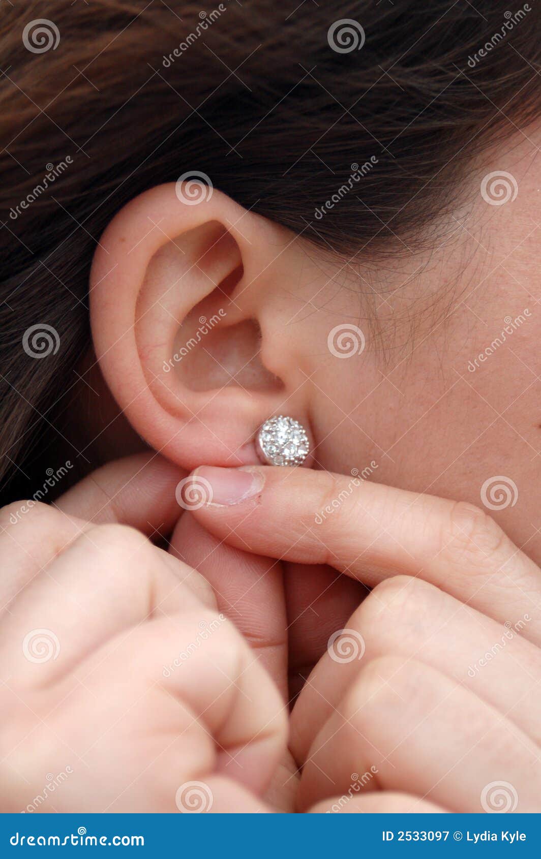 Putting earrings on stock image. Image of earlobe, hands 2533097