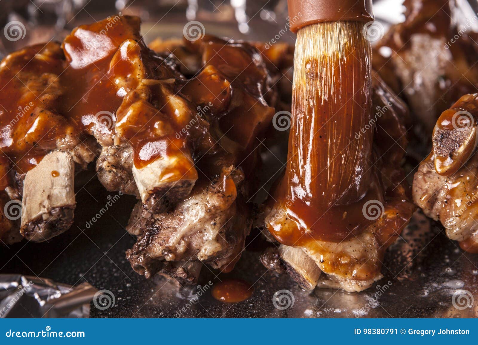 Putting sauce on ribs. stock image. Image of brush, close 98380791