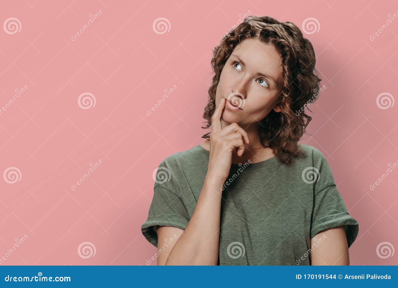 Puzzled Curly Woman Holds Chin, Looks Thoughtfully Upwards, Being ...