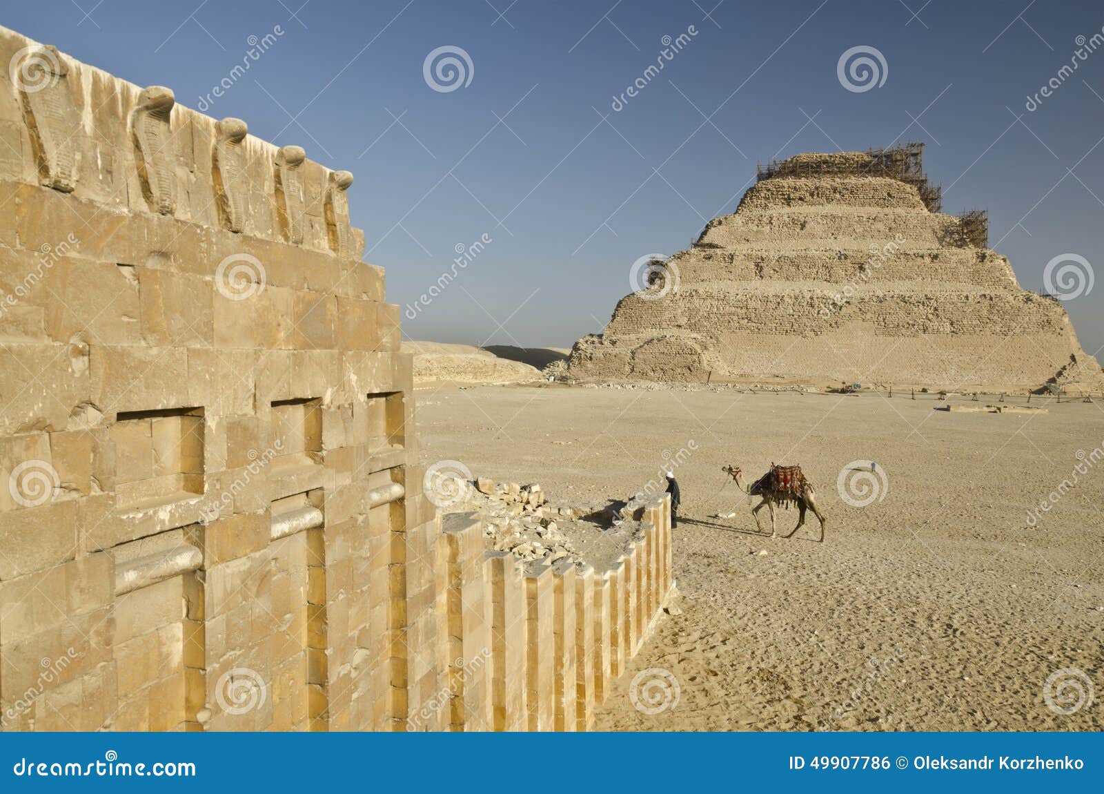 pyramid of djoser and temple wall with cobras in saqqara