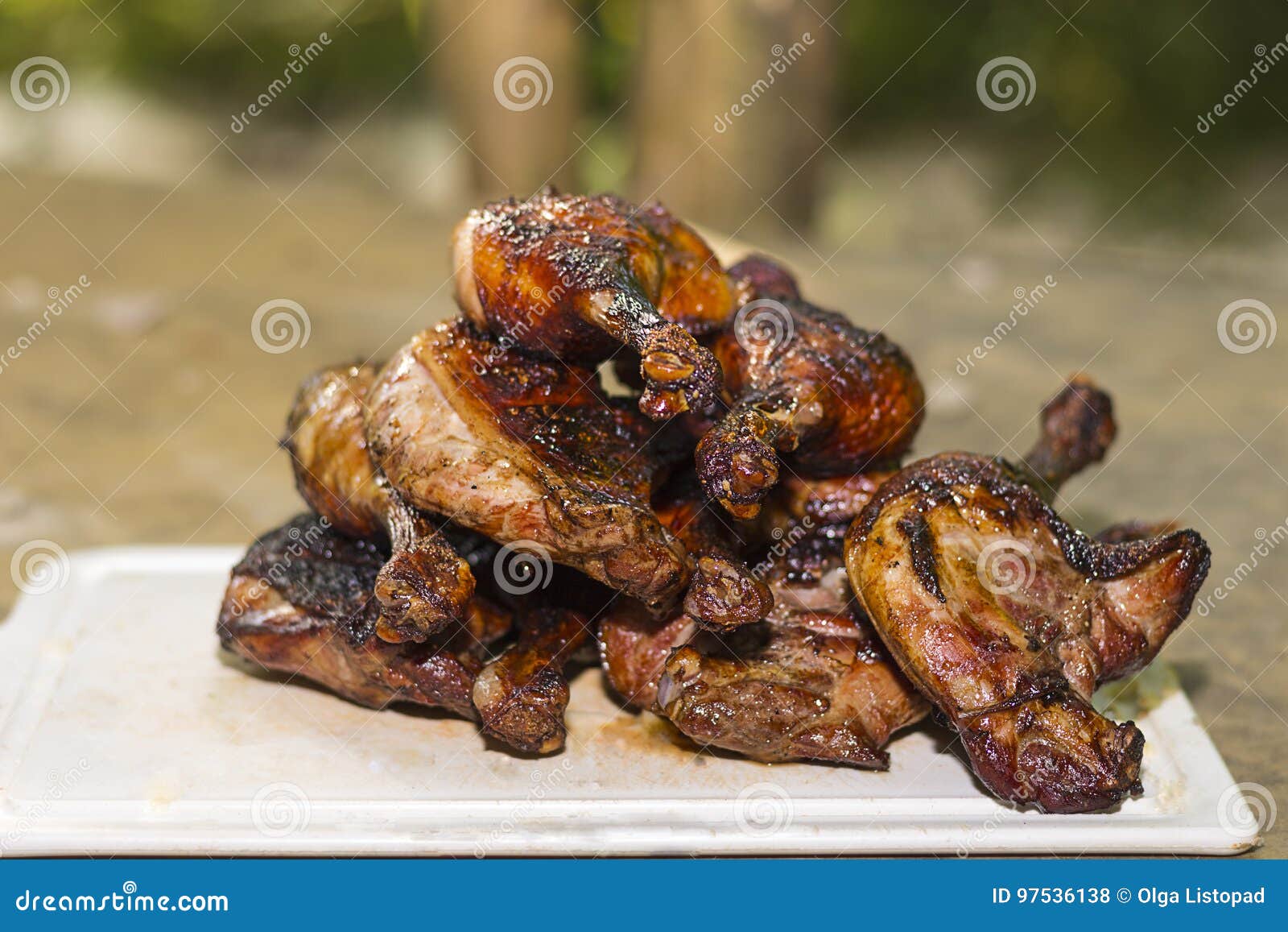 Pyramid of Grilled Duck Legs on the Board. Outdoor Barbeque Stock Photo