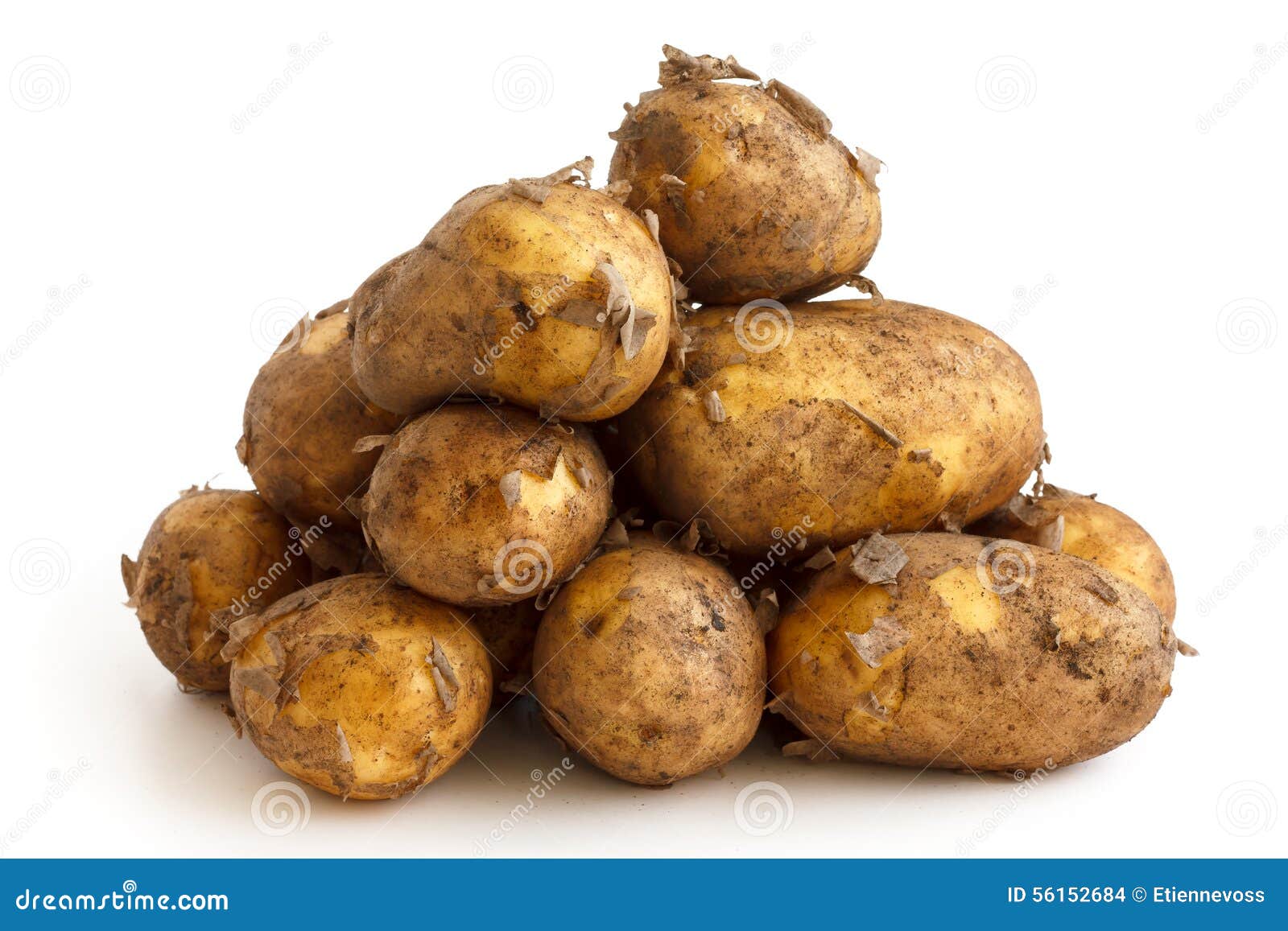 pyramid heap of unwashed new potatoes  on white.