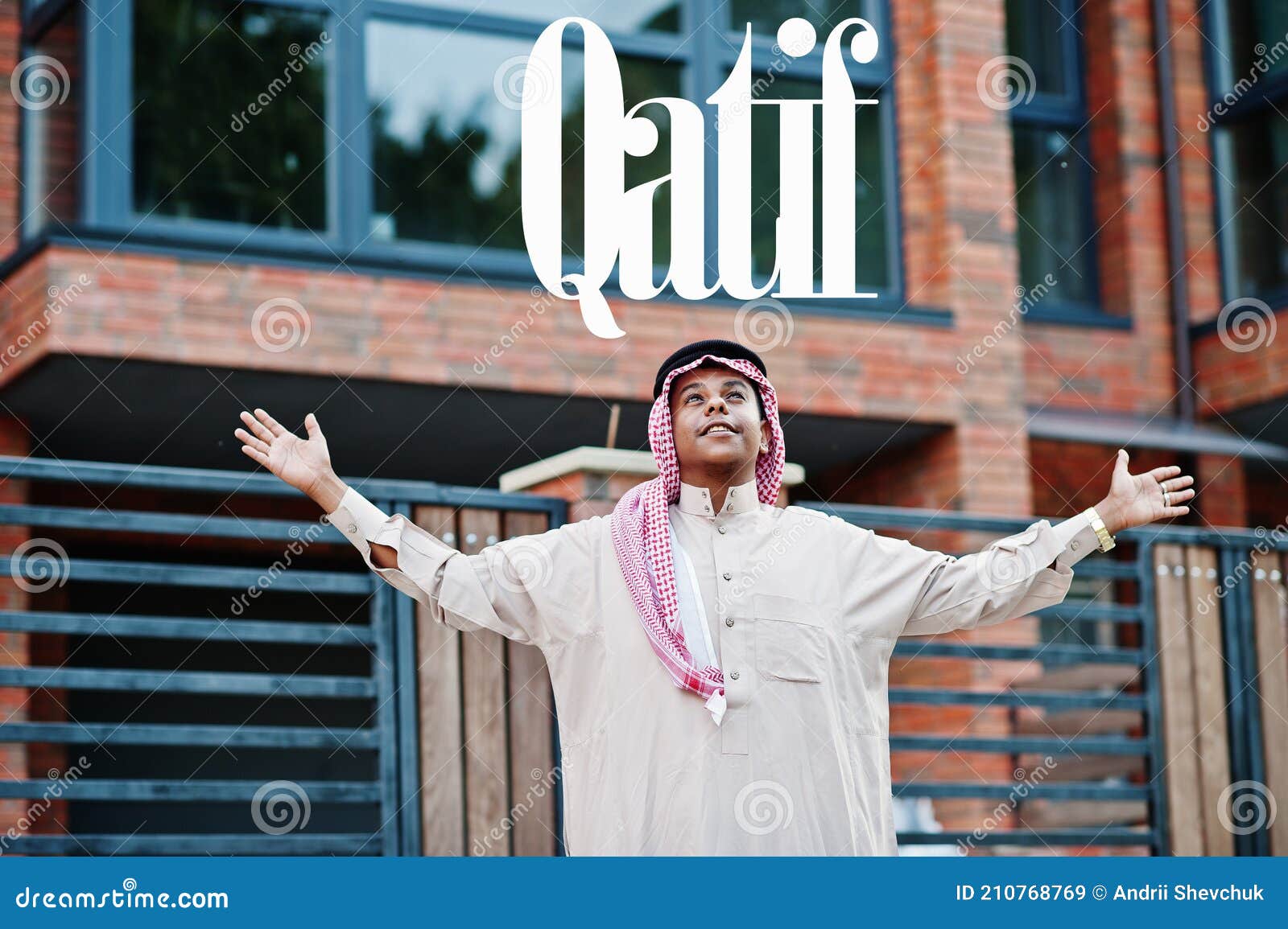 qatif - biggest city of saudi arabia. middle eastern saudi arabian man posed on street against modern building up his hands in the