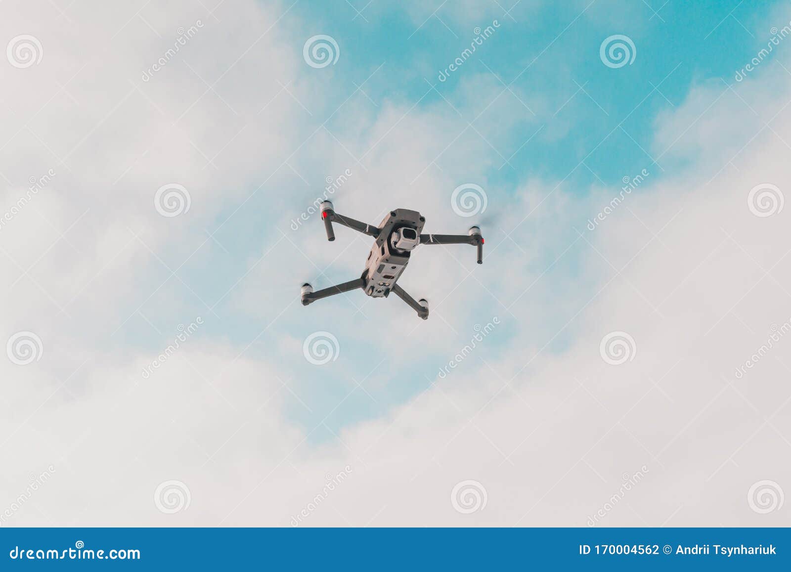 a quadcopter with a built-in camera flies into the sky, captures video footage of the photo
