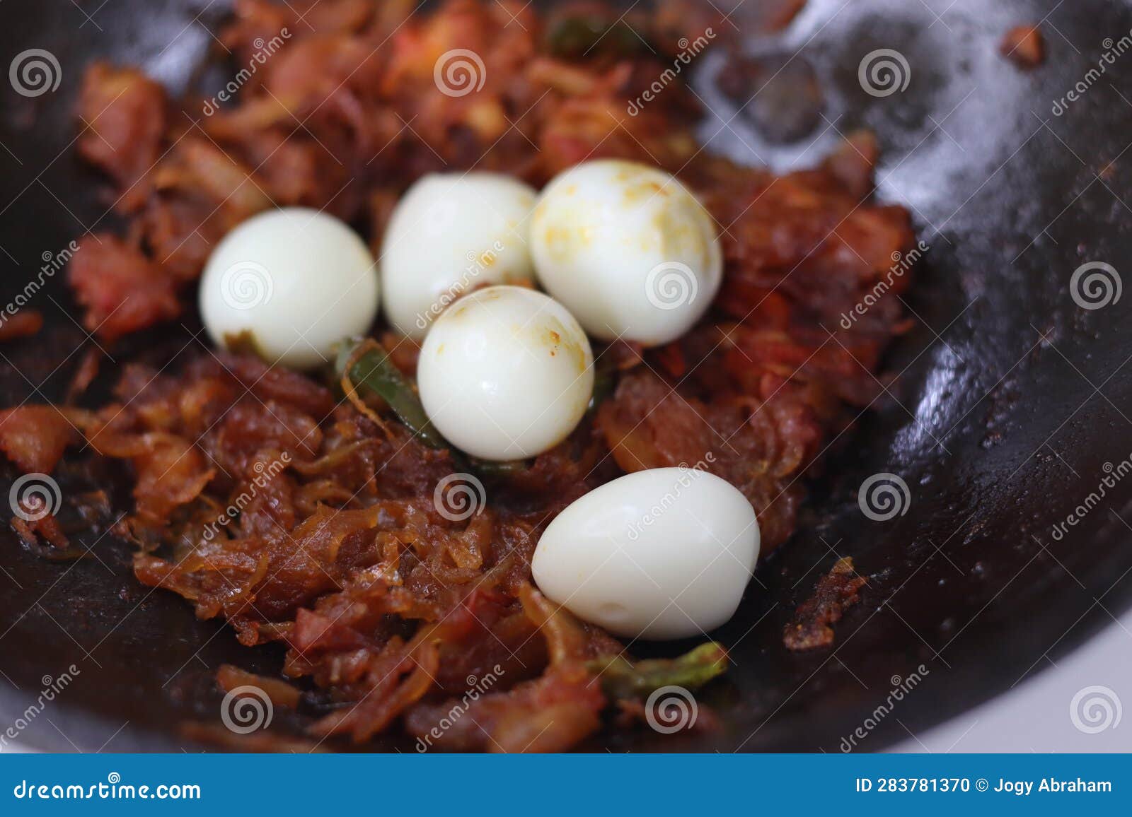 Quail Egg Roast Cooked Kerala Style Served in Cast Iron Pan Stock Photo