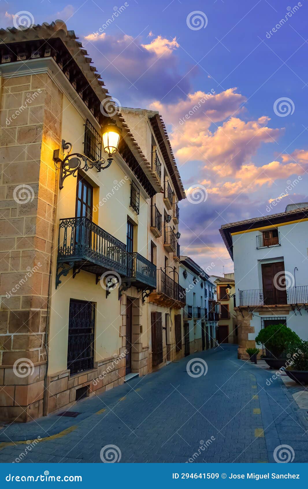 quaint houses with lit street lamps in a white village of almeria, velez rubio, spain.