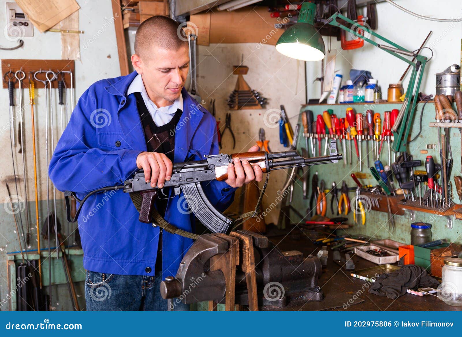Gunsmith Performing Maintenance Of Kalashnikov Assault Rifle In