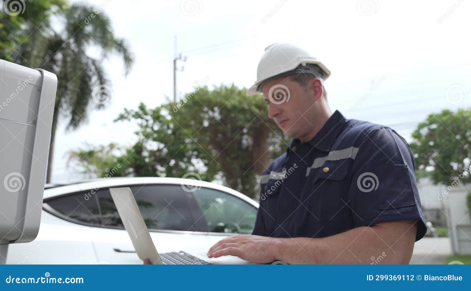 Qualified Technician Working with Laptop for Home EV Station
