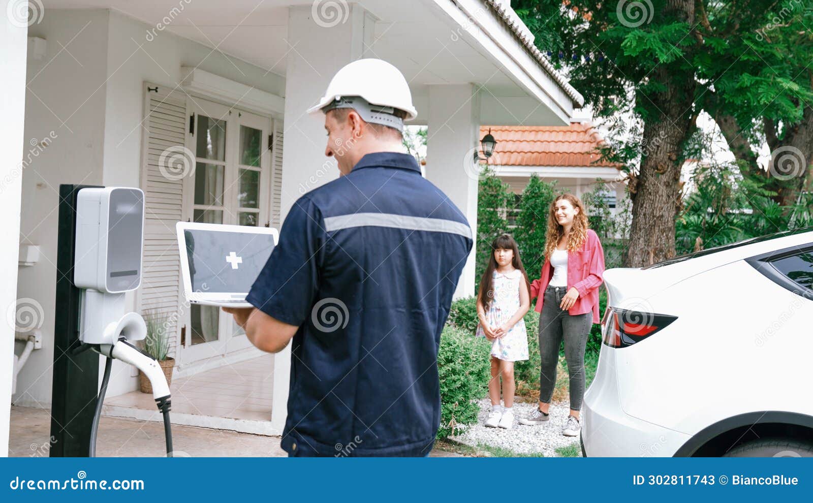 Qualified Technician Working with Laptop for Home EV Station