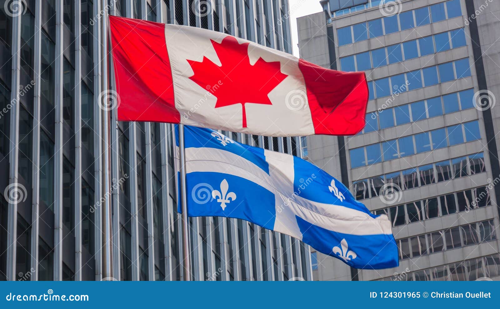 Quebec and Canada Flags Fluttering in the Wind Together in the Downtown