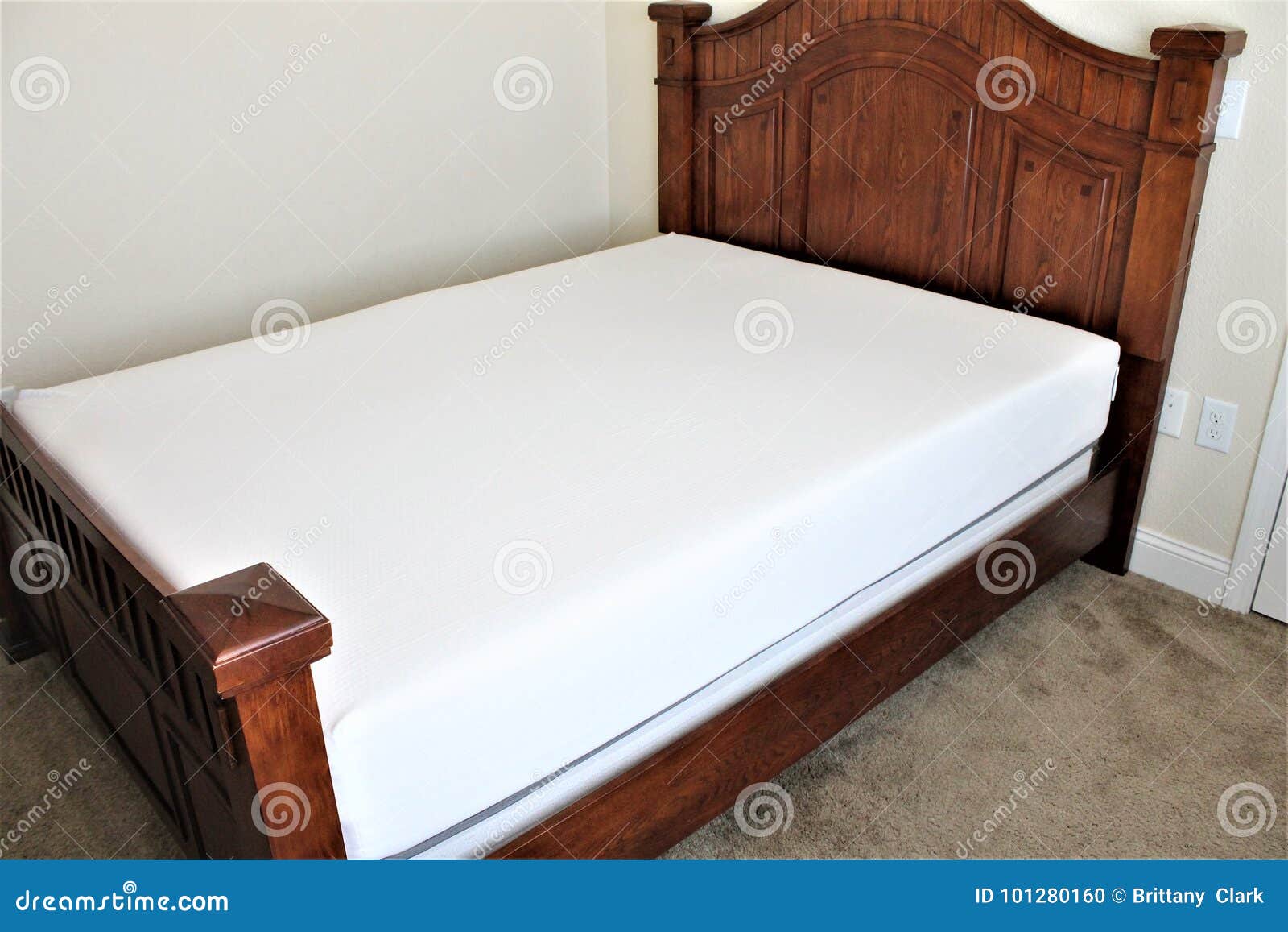 Queen Sized Bed Unmade in a Bedroom with a Foam Mattress Stock Photo