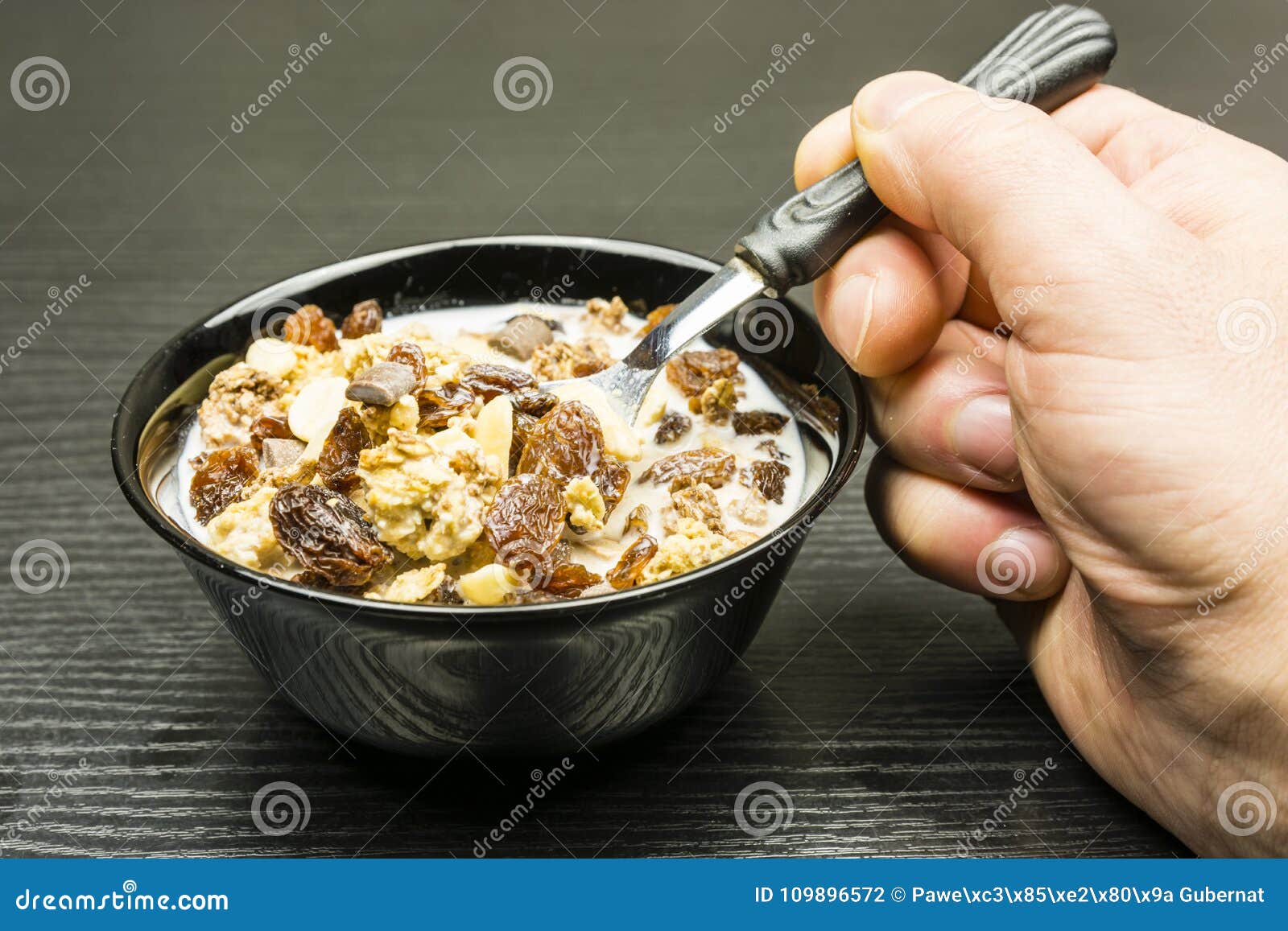 Quick Healthy Breakfast. Bowl with Roasted Crunchy Cocoa Muesli with  Peanuts, Milk Chocolate, Caramel and Raisins with Milk. Stock Photo - Image  of delicacy, hold: 109896572