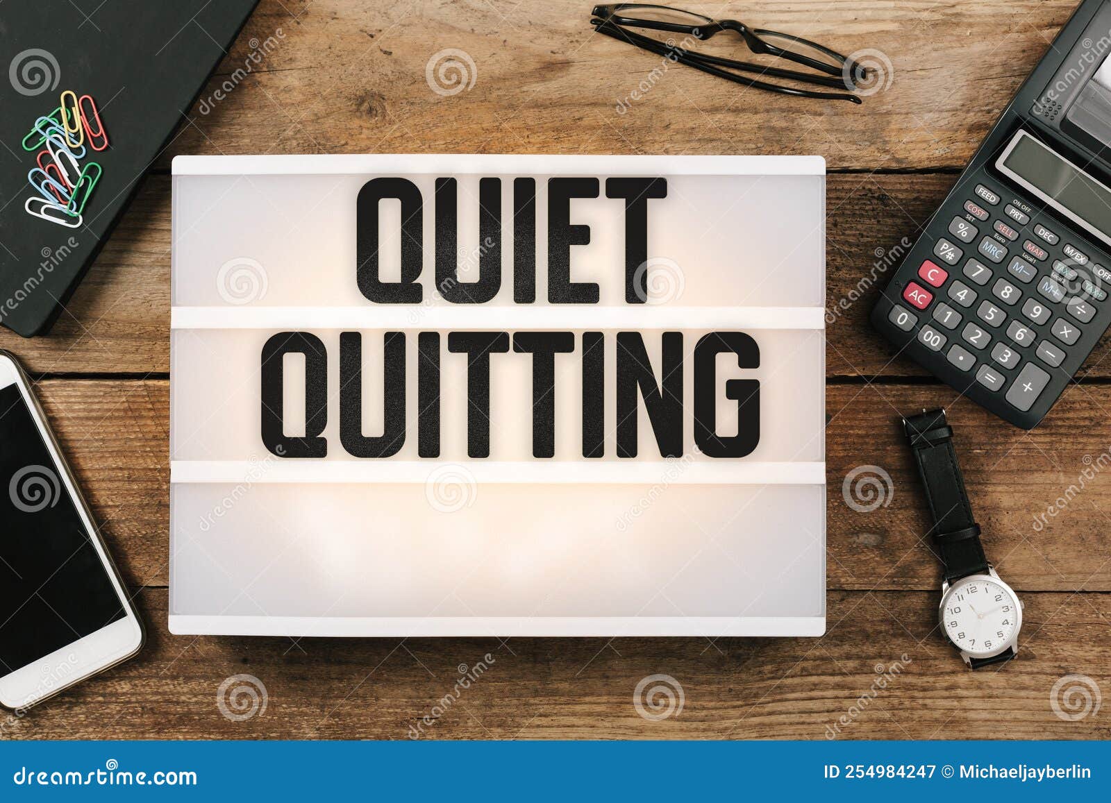 quiet quitting text headline in vintage style light box on office deskt op