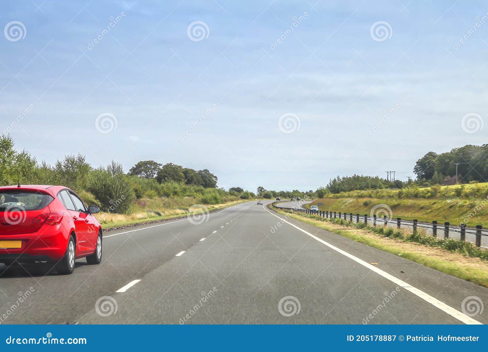 Quiet Road with Red Car Driving on Left Side Stock Image Image of
