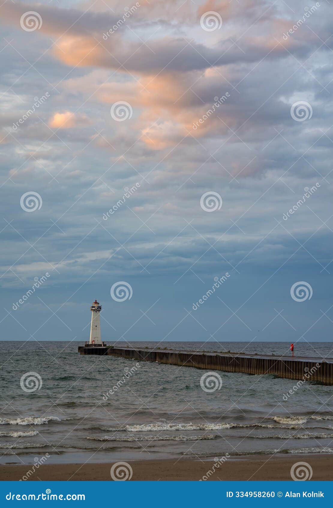 quiet sunset lights pink clouds over the sodus point lighthouse