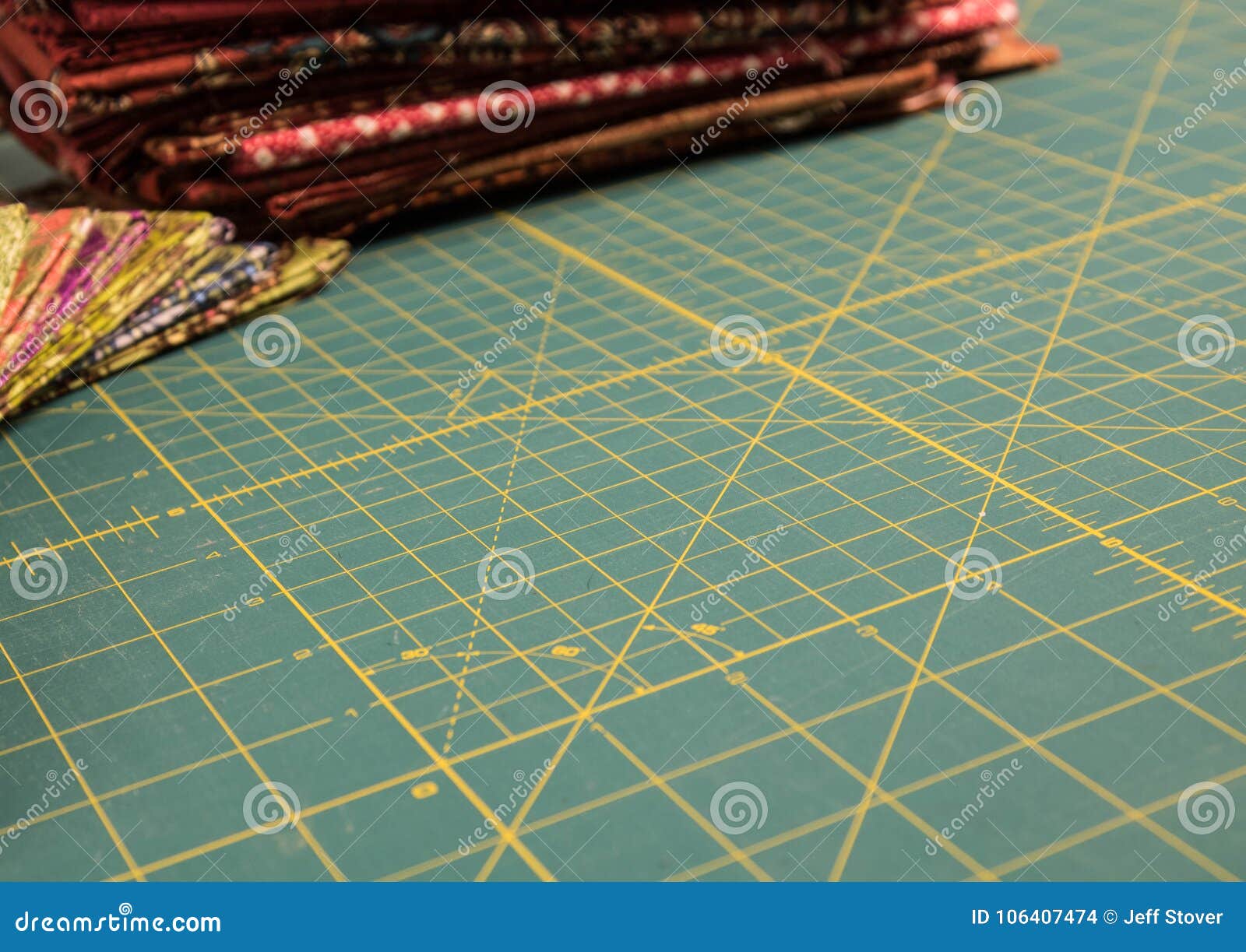 Quilt Rotary Cutting Mat With Multicolored Fabric In Background