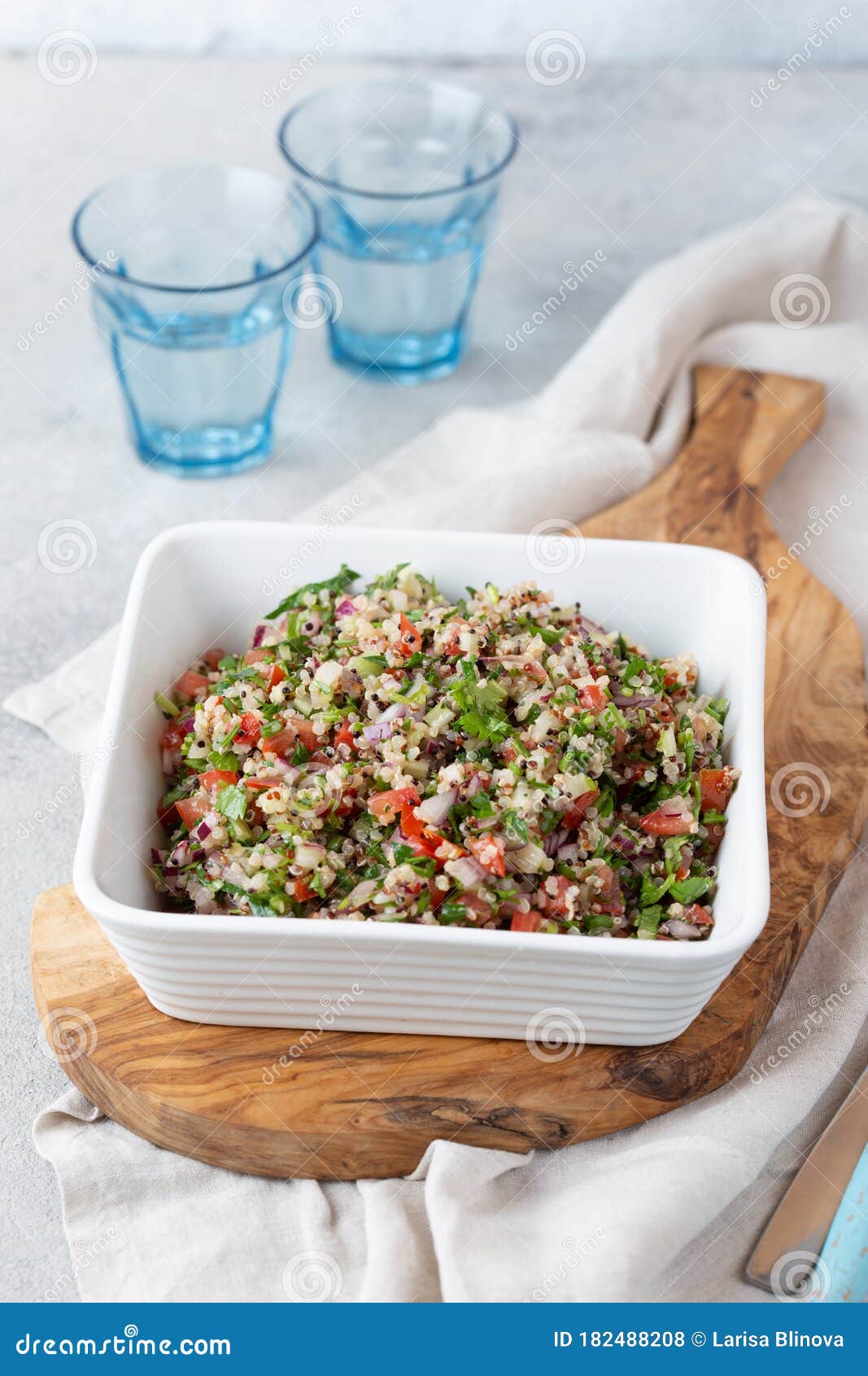 quinoa quinua salad with tomatoes and herbs in white bowl