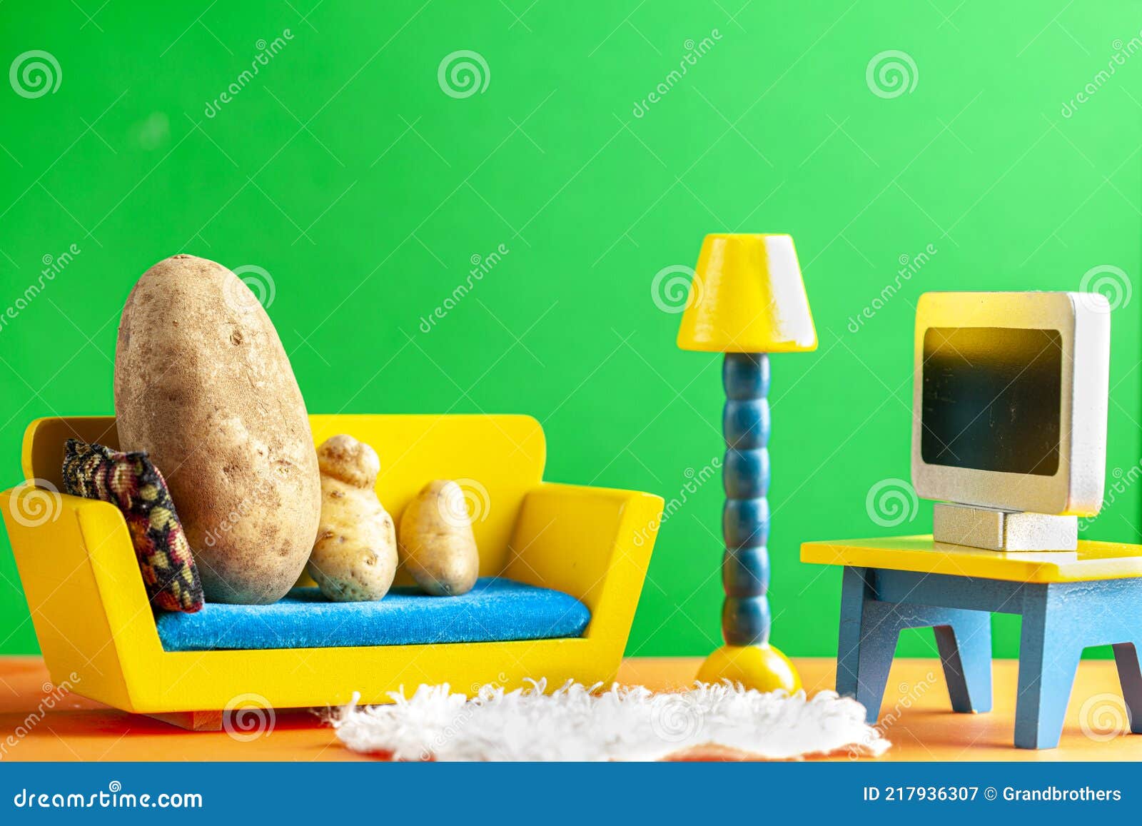 a quirky metaphorical concept image showing a potato family lying on a couch watching tv