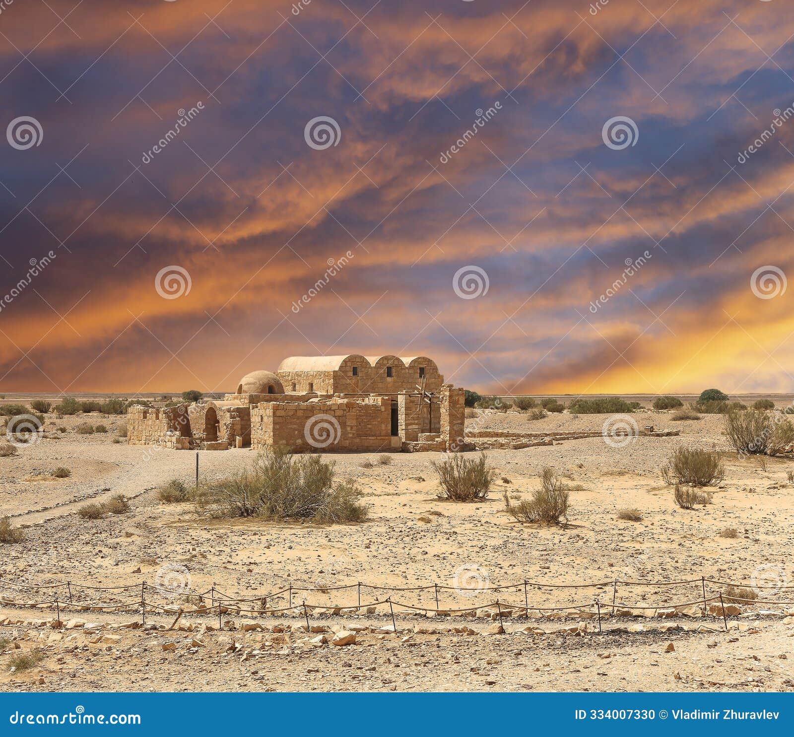 quseir (qasr) amra desert castle (against the sky with clouds) near amman, jordan.