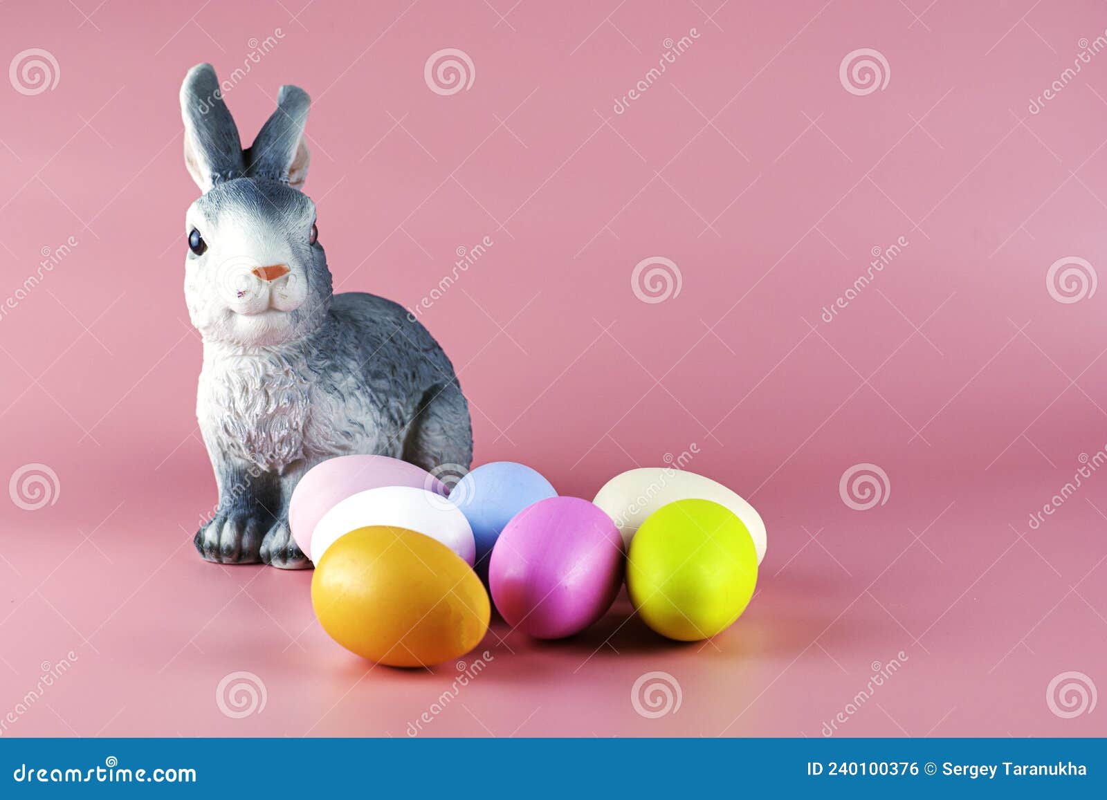 Rabbit and Painted Multicolored Easter Eggs on Pink Background Stock ...