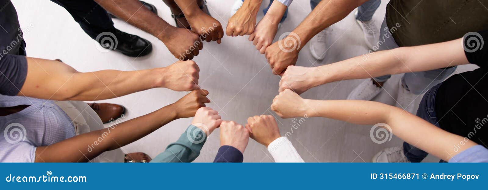 racial diversity team huddle: spirited fist circle