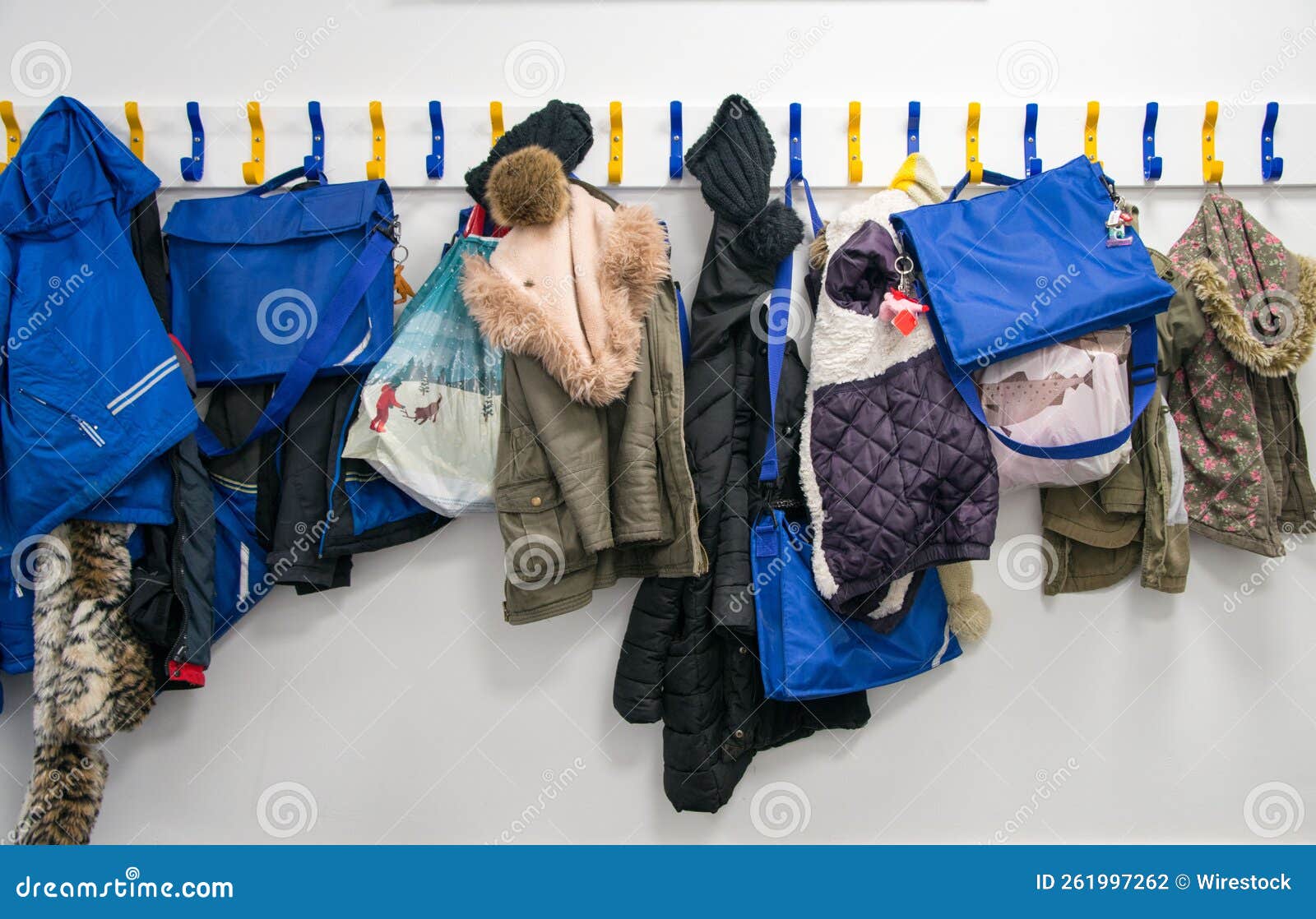 Rack of coats on pegs stock photo. Image of sweater 261997262