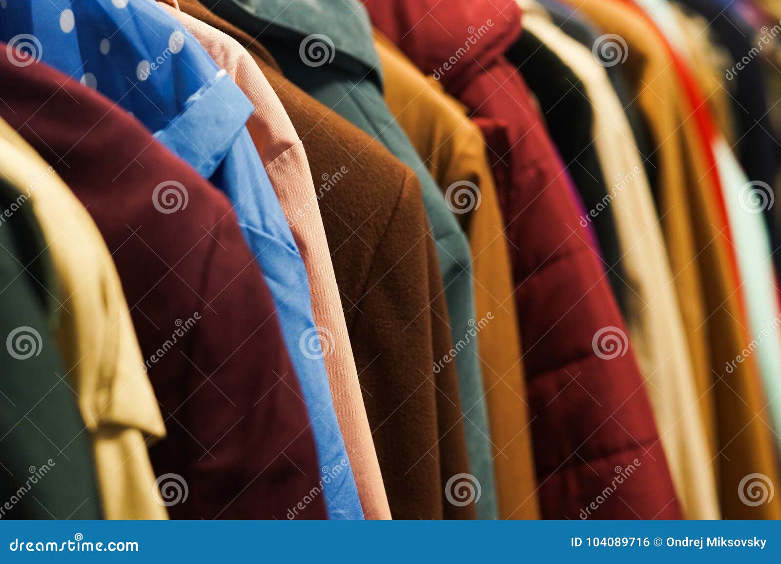colourful coats in the charity shop.