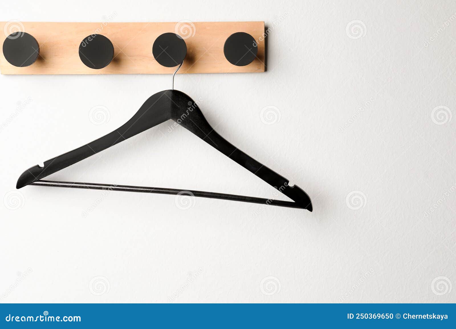 Rack with Empty Black Clothes Hanger on White Wall Stock Photo Image