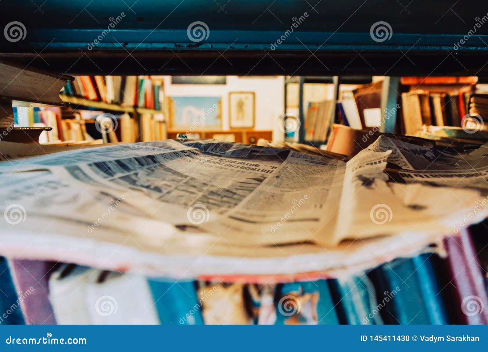 Rack with Newspapers and Old Books. on the Shelf of the Newspaper and
