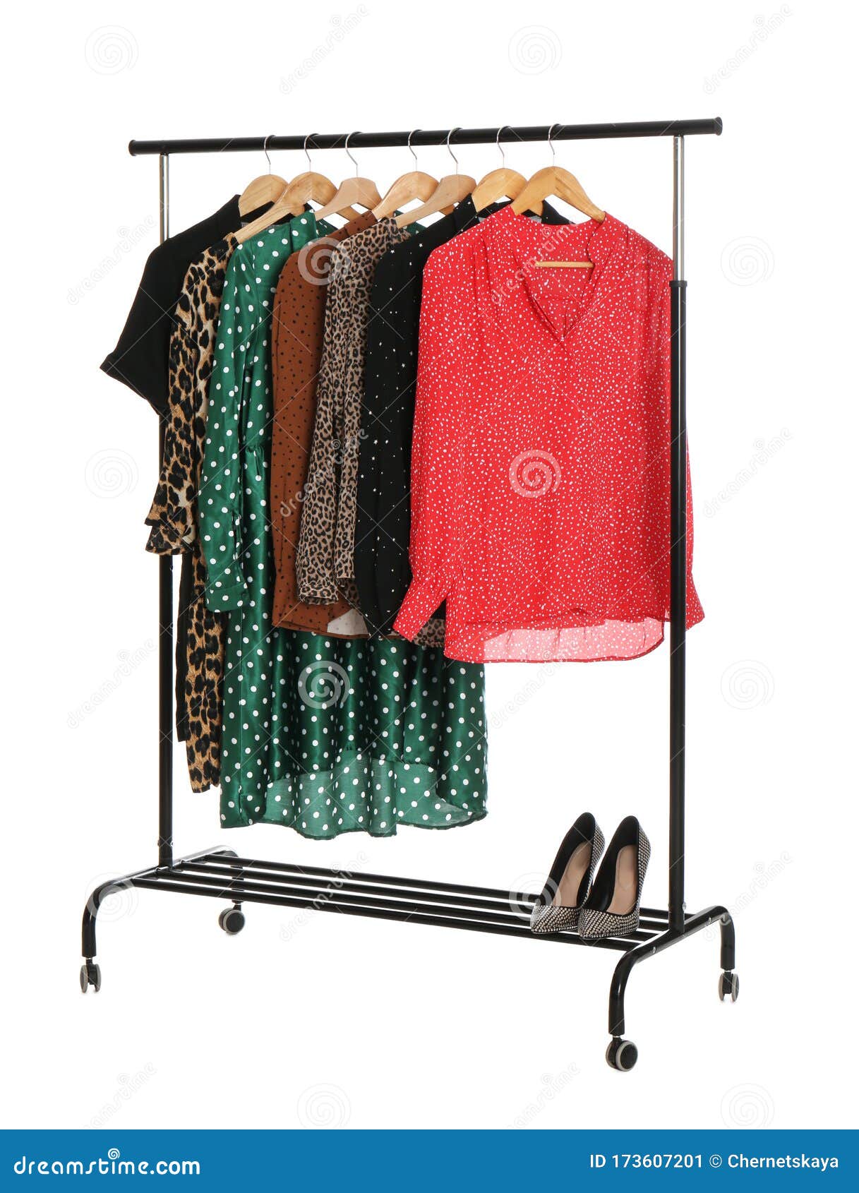 rack with stylish women`s clothes on white