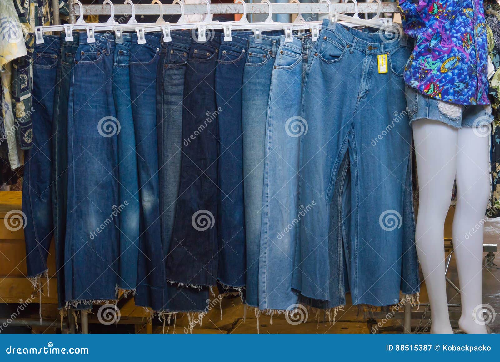 A Rack of a Variety of Blue Denim Jeans in Various Shades of Blu Stock ...