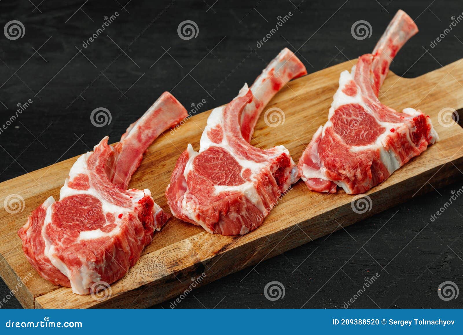 Racks of Lamb Ready for Cooking on Dark Background Stock Photo Image