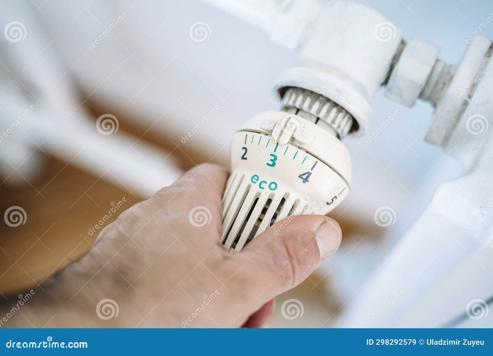 Radiator Thermostat and Hand. Heating House in Winter Stock Image