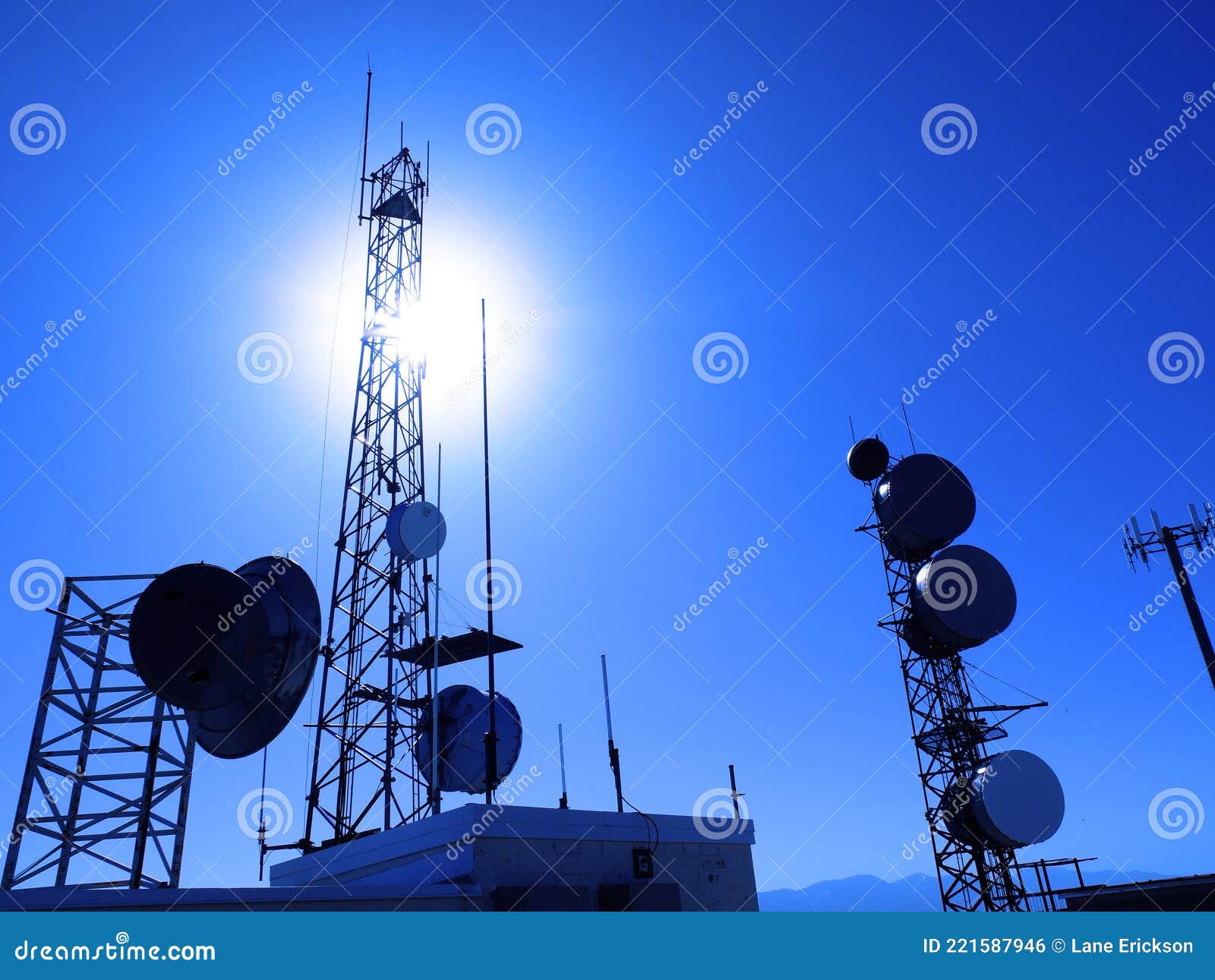 Radio Towers for Transmissions Satellites with Blue Sky and Sun Stock