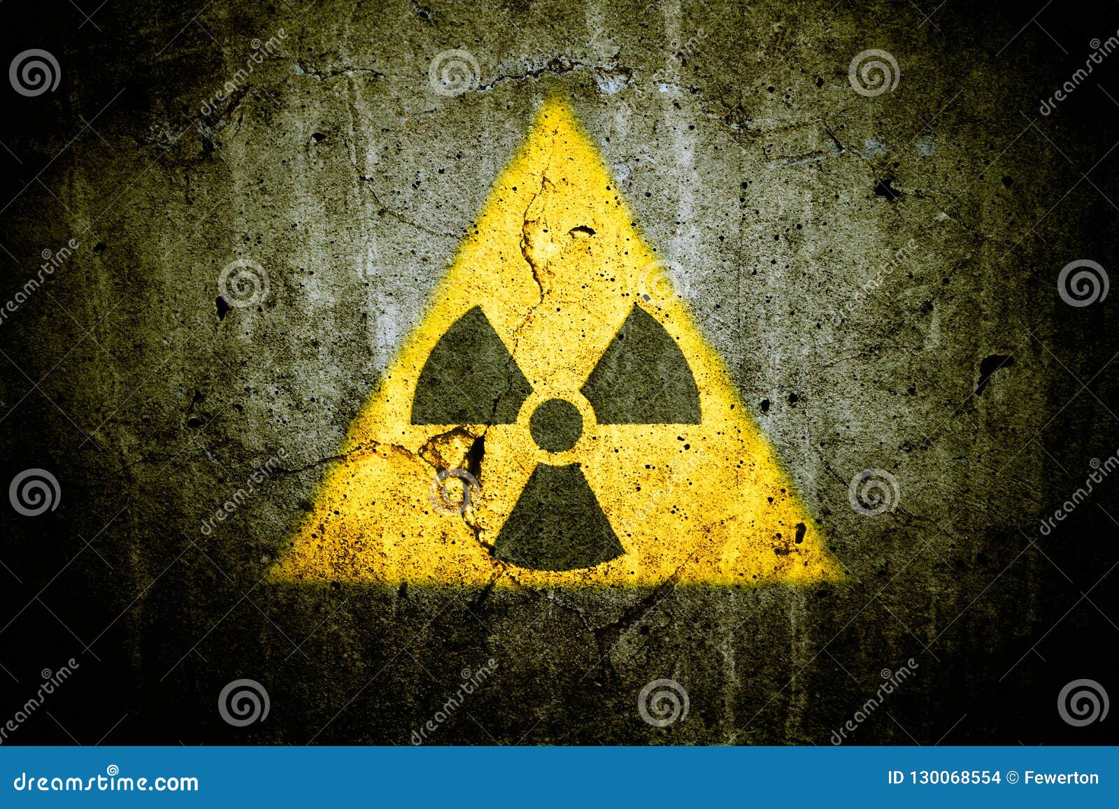 radioactive atomic nuclear ionizing radiation danger warning  in triangular  painted massive cracked concrete wall