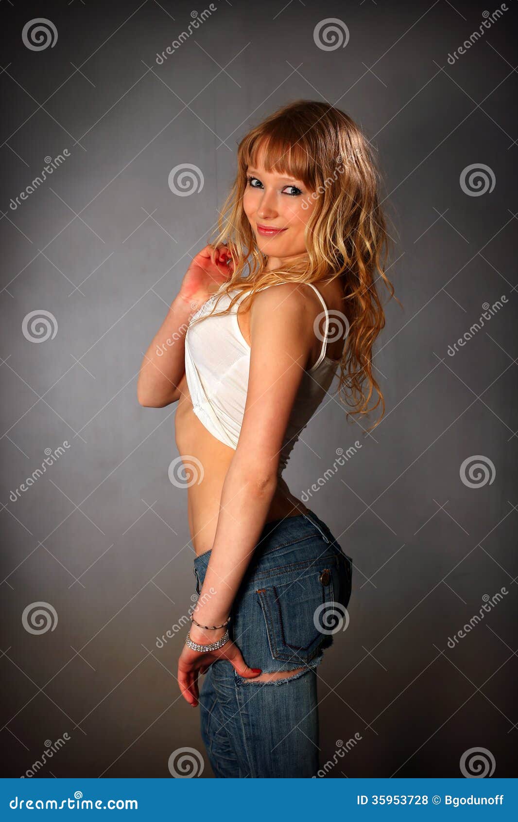 Ragazza bionda in jeans. Giovane ragazza bionda splendida in jeans che posano nello studio