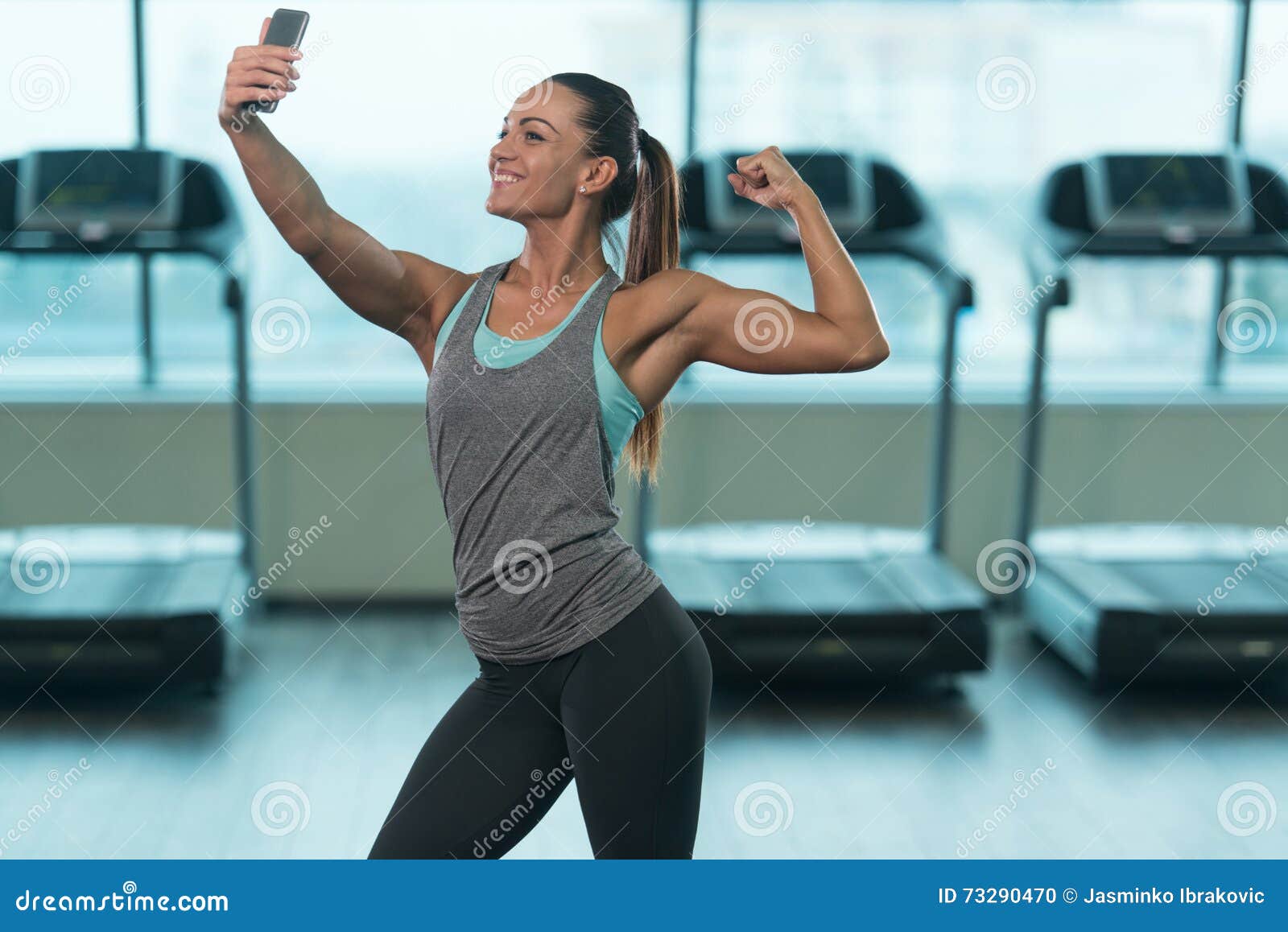 Sport donna prendendo selfie davanti a uno specchio in palestra