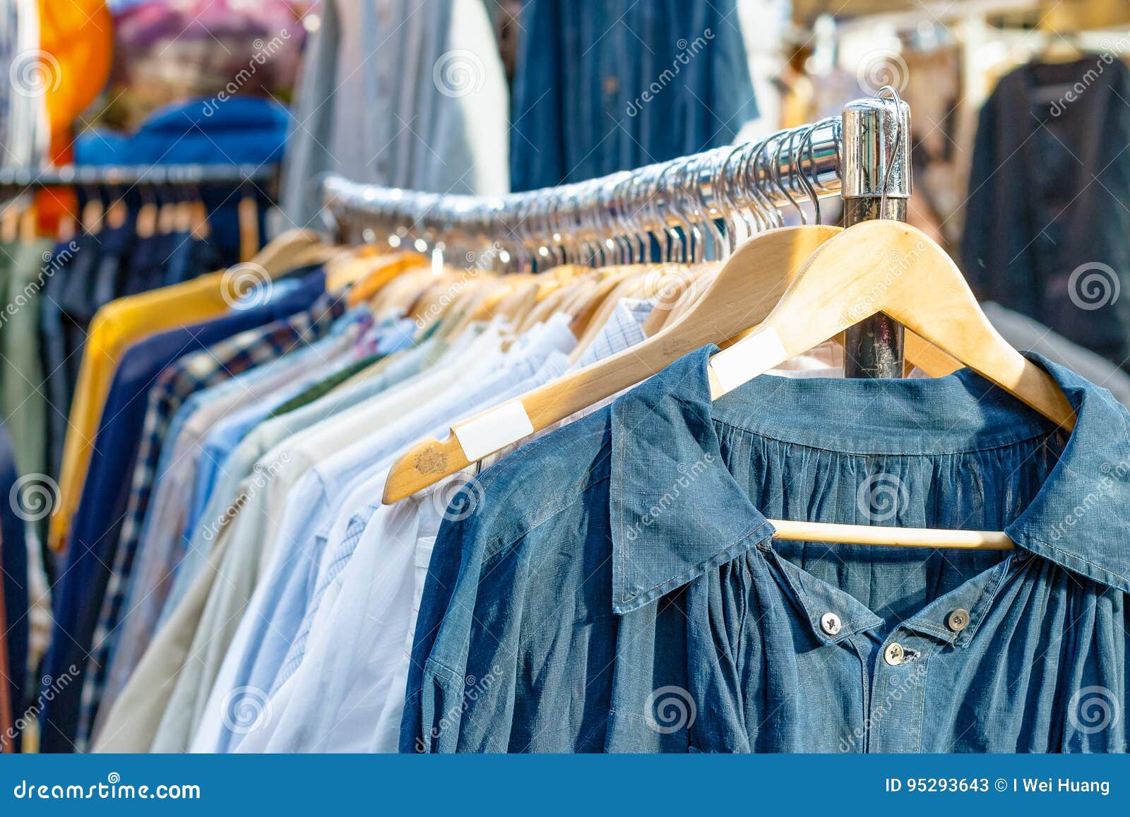 rail of second-hand clothes on display