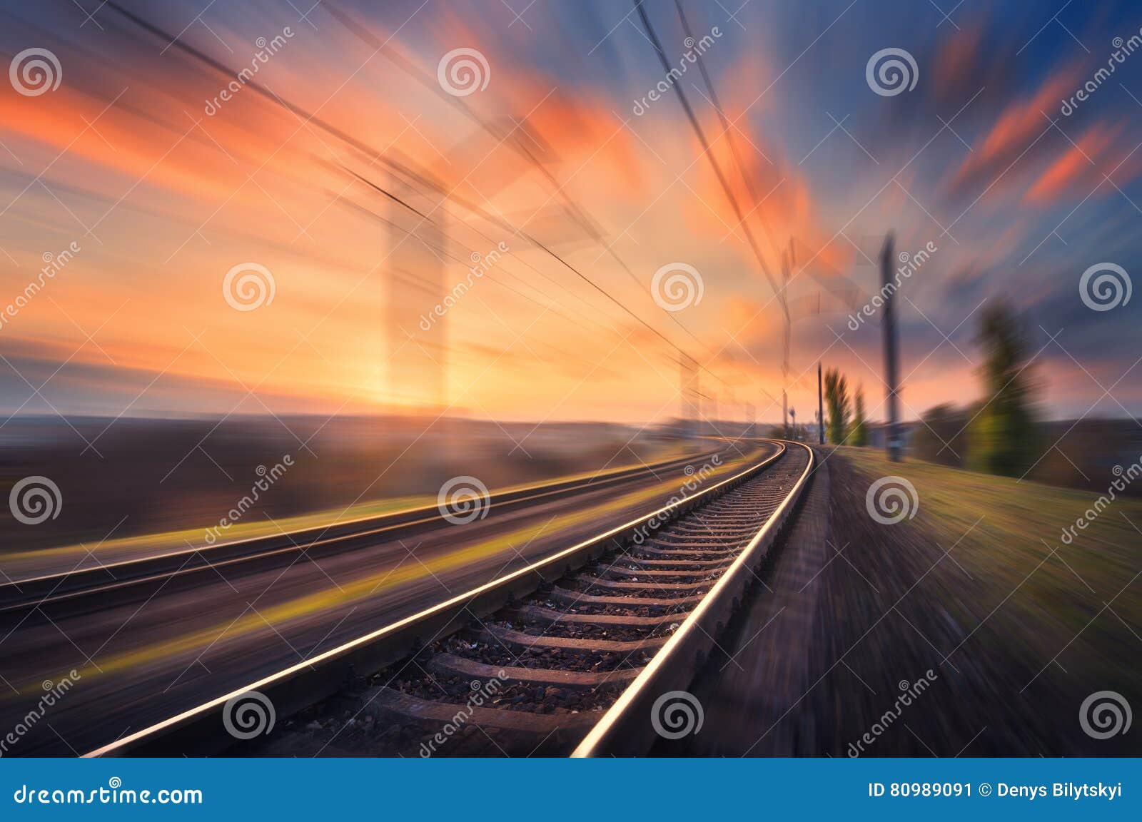 railroad in motion at sunset. blurred railway station