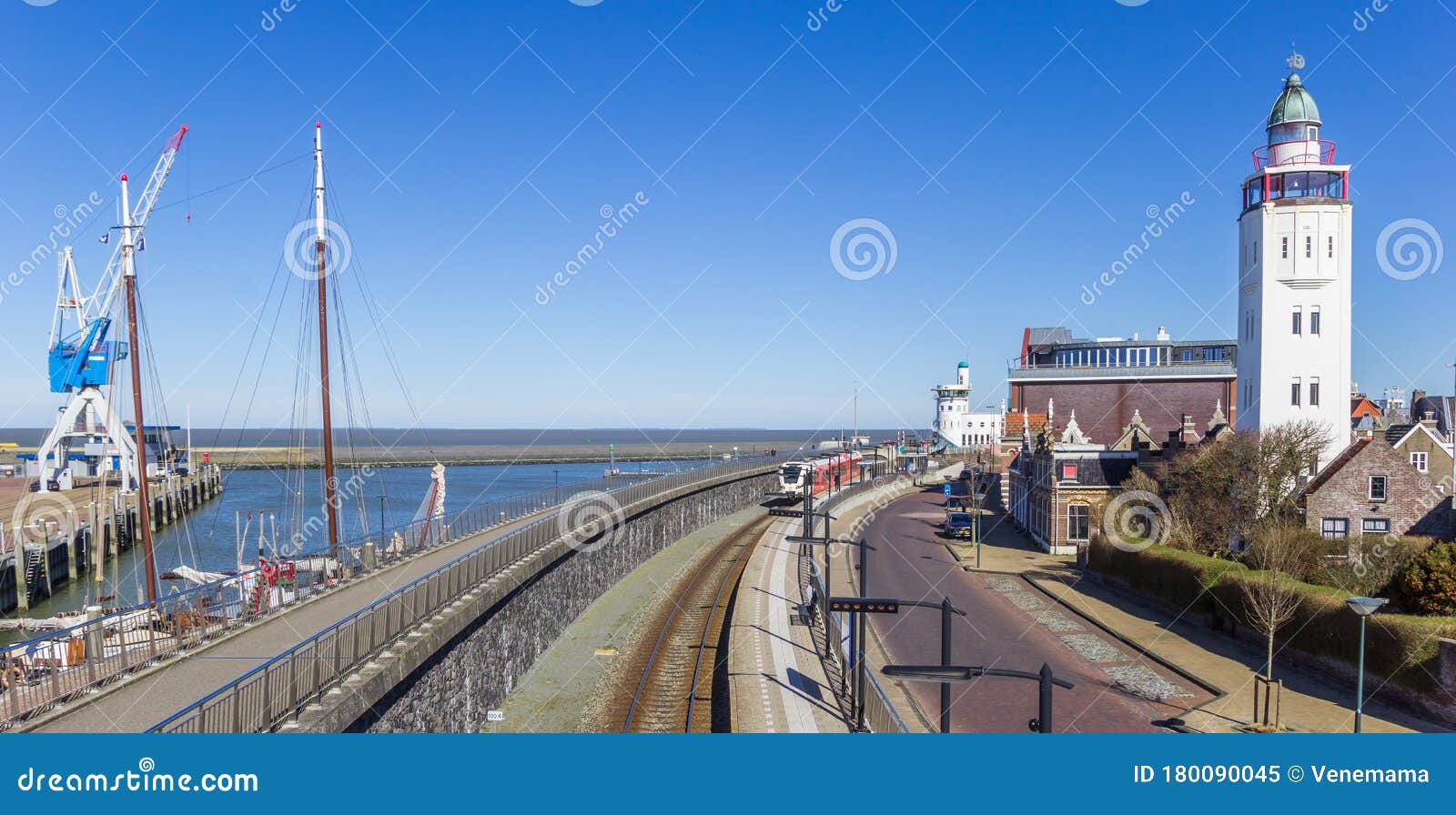 Railroad Track and Lighthouse in the Harbor of Harlingen Editorial