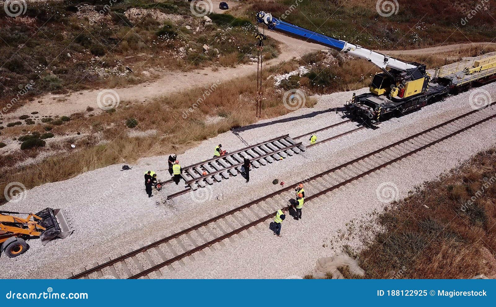Railway Workers Walking Along Railway Tracks High-Res 