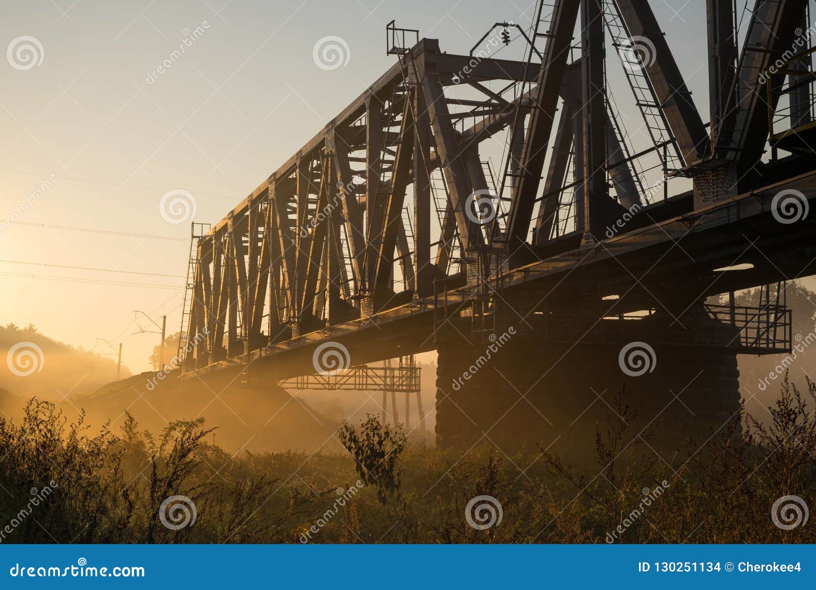 railway bridge over the irpin river in the autumn foggy morning