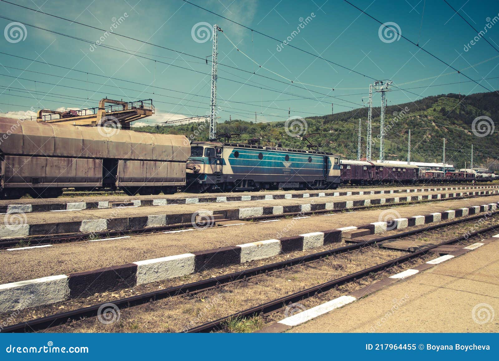 Freight Trains at a Railway Station with Details of Wagons and Blue Sky