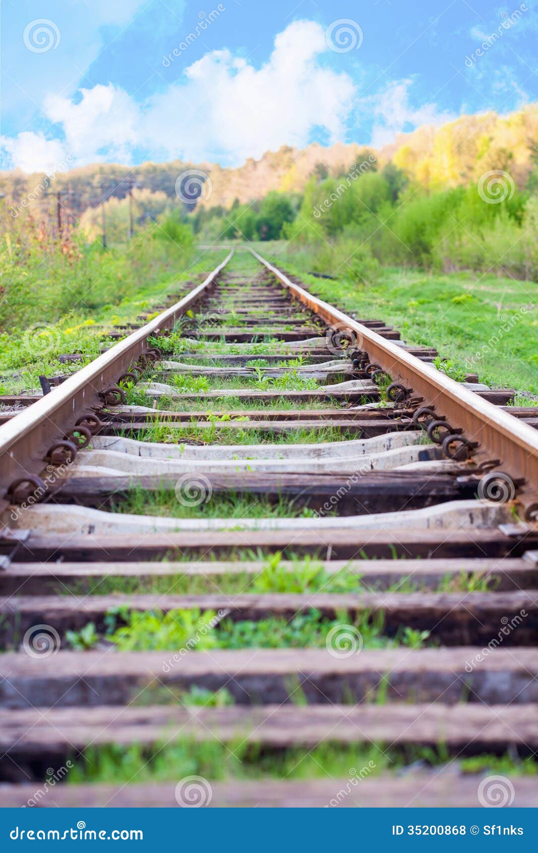 Railway Tracks in a Rural Scene with Nice Blue Sky Stock Photo Image