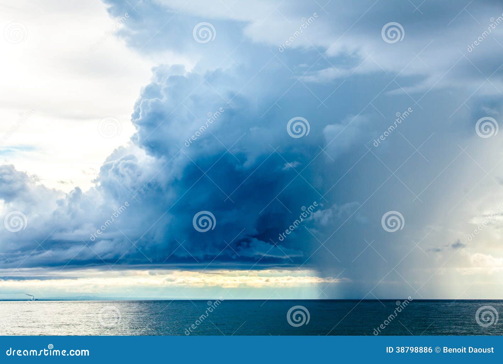 rain clouds at the sea horizon
