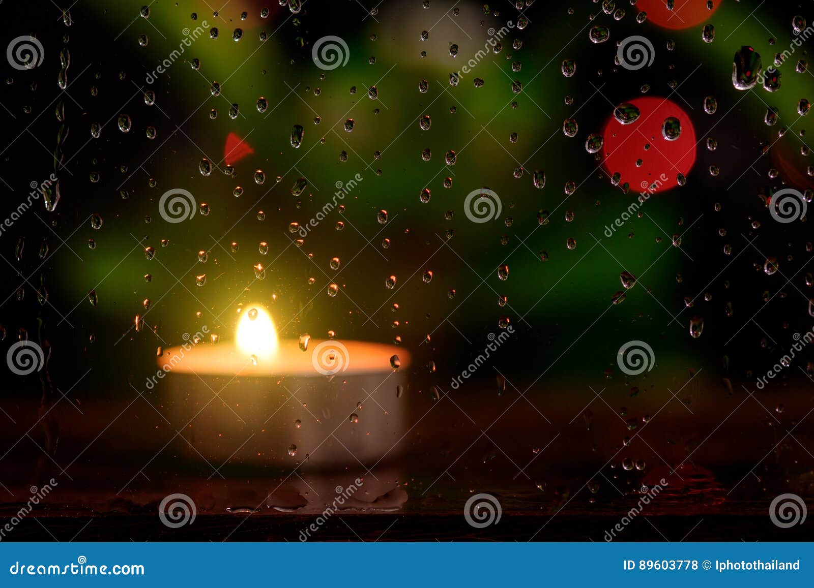 Rain Drop on Mirror with Blurred Image of Candle Light. Stock Photo