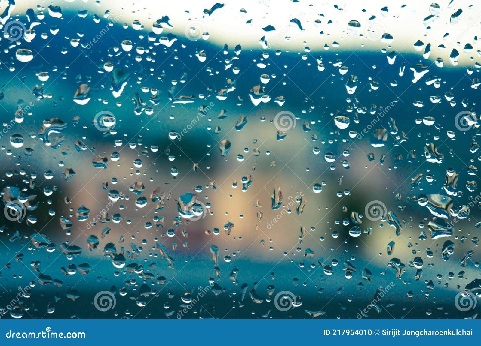 Rain Drops on Window Glasses Surface with Sunset. Drops on Glass Spray