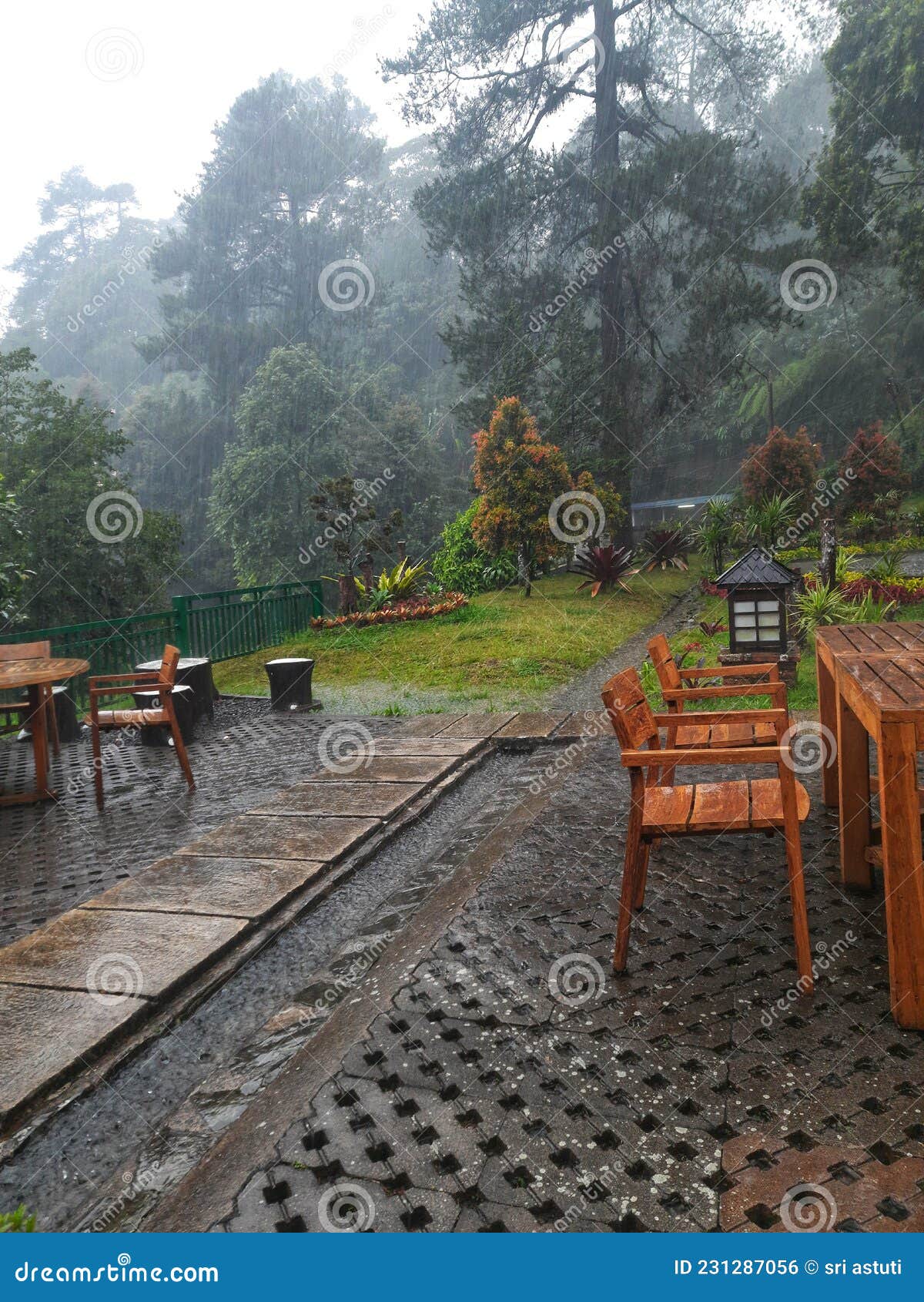 Rain soaks outdoor seating stock photo. Image of garden 231287056